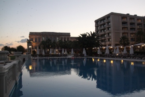 The pool at sunset, with the palace in the distance alongside the main building